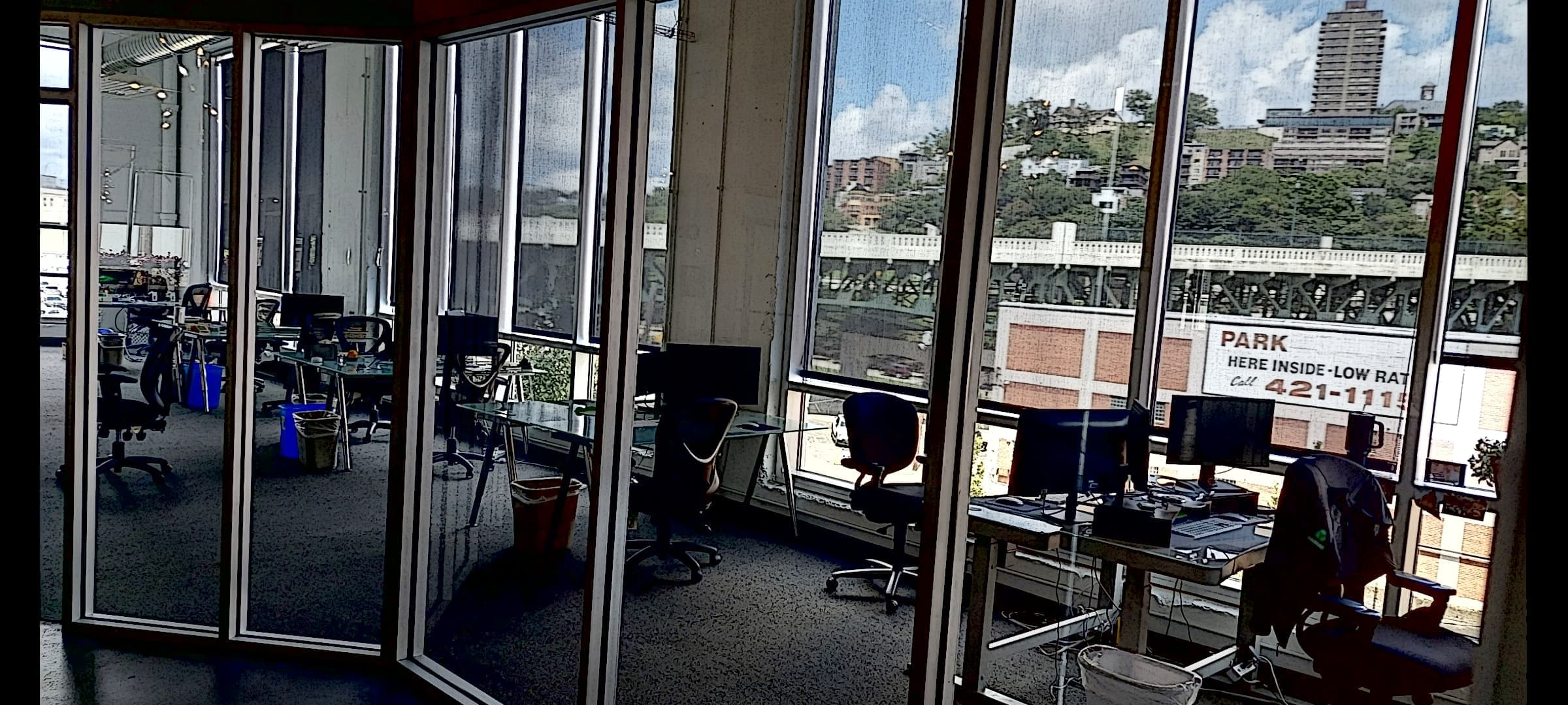 Interior office space with floor-to-ceiling windows overlooking the riverfront